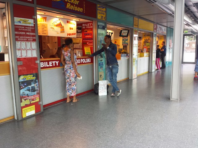 Ticket counter at a bus station. Each of them is advertising tickets to Poland in the Polish language.
