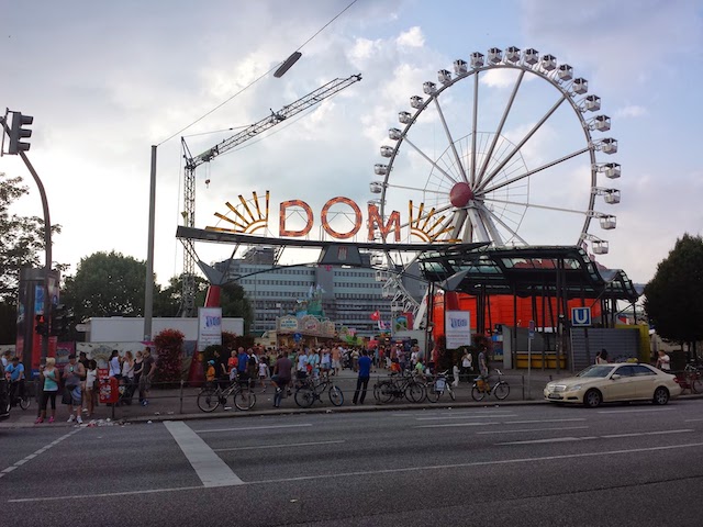 Entrance to a lunapark with an illuminated gate headed with a word DOM.